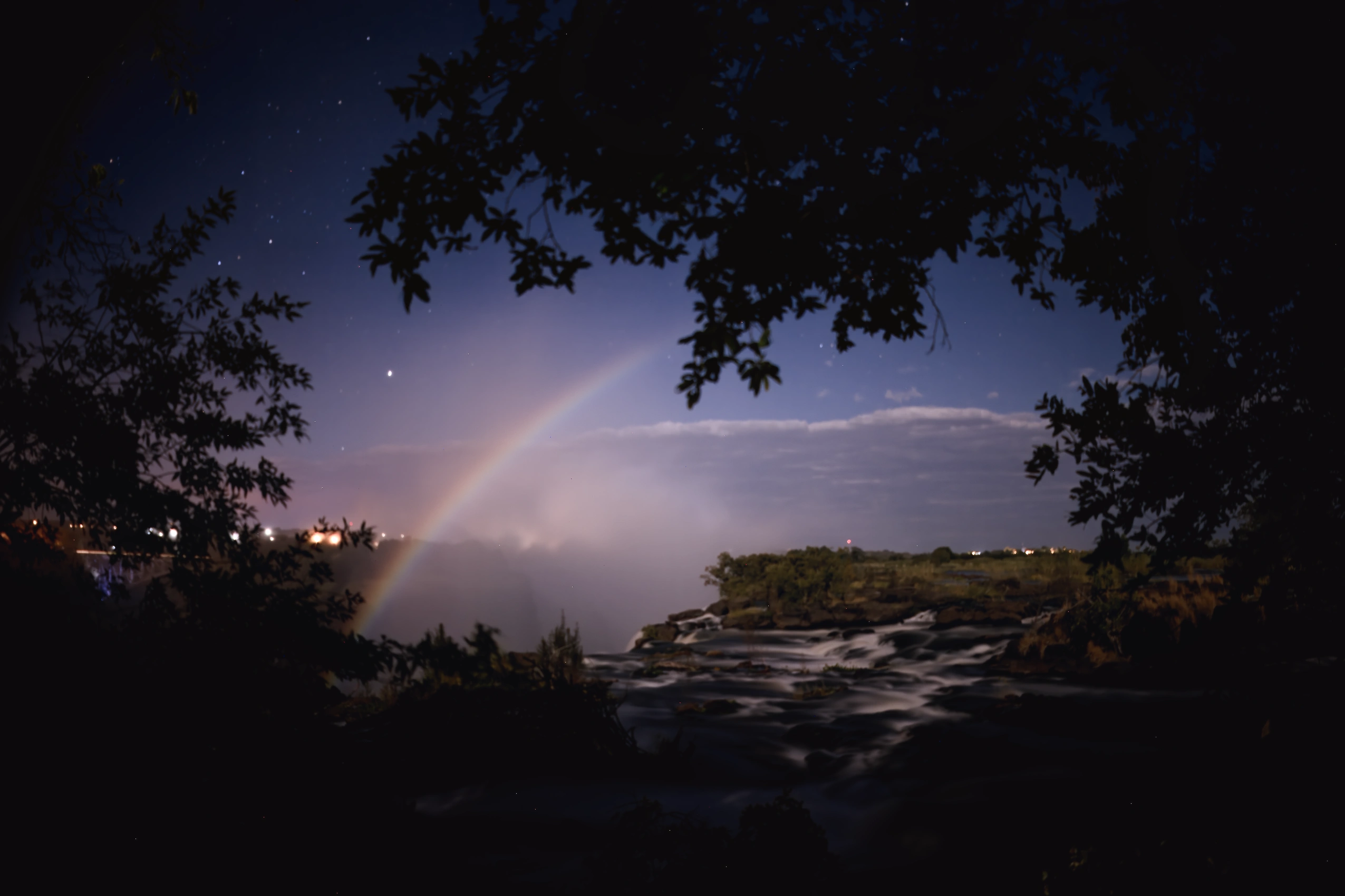 A rare rainbow born from moonlight over Victoria Falls